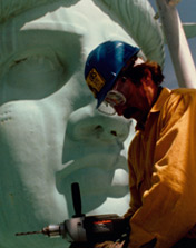 A worker near the Statue's face during restoration circa 1984.