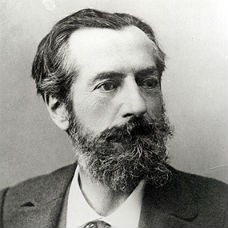 Black and white photo of a man with dark eyes and a substantial beard.