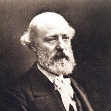 A gentleman with a bald head and full beard.