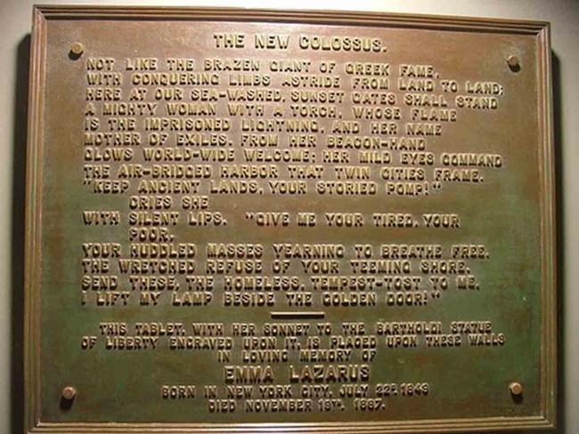 Image of the words of the New Colossus inscribed on a bronze plaque.