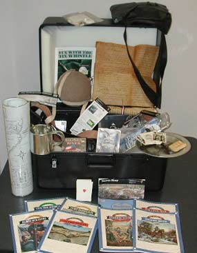 An open trunk filled with books, papers and Civil War items.