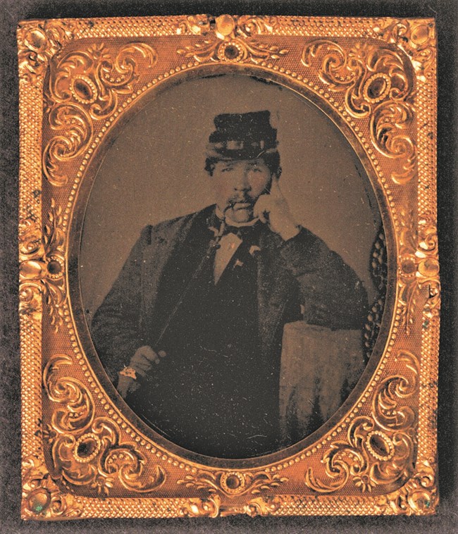 A Civil War Soldier smokes a pipe