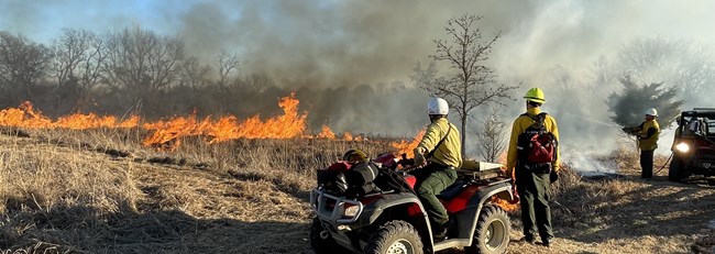 Photo of fire team with a four-wheeler observing a prescribed burn