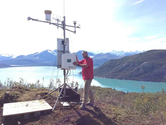 A scientist installing a weather station
