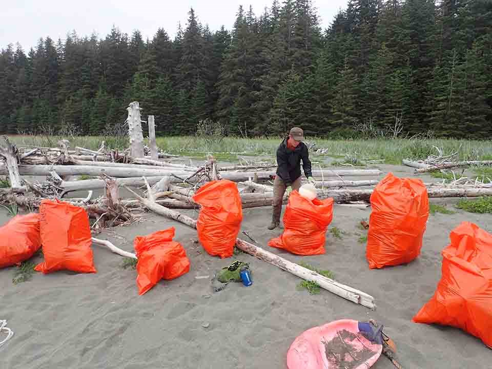Large bags of marine debris collected at a beach near Yakutat