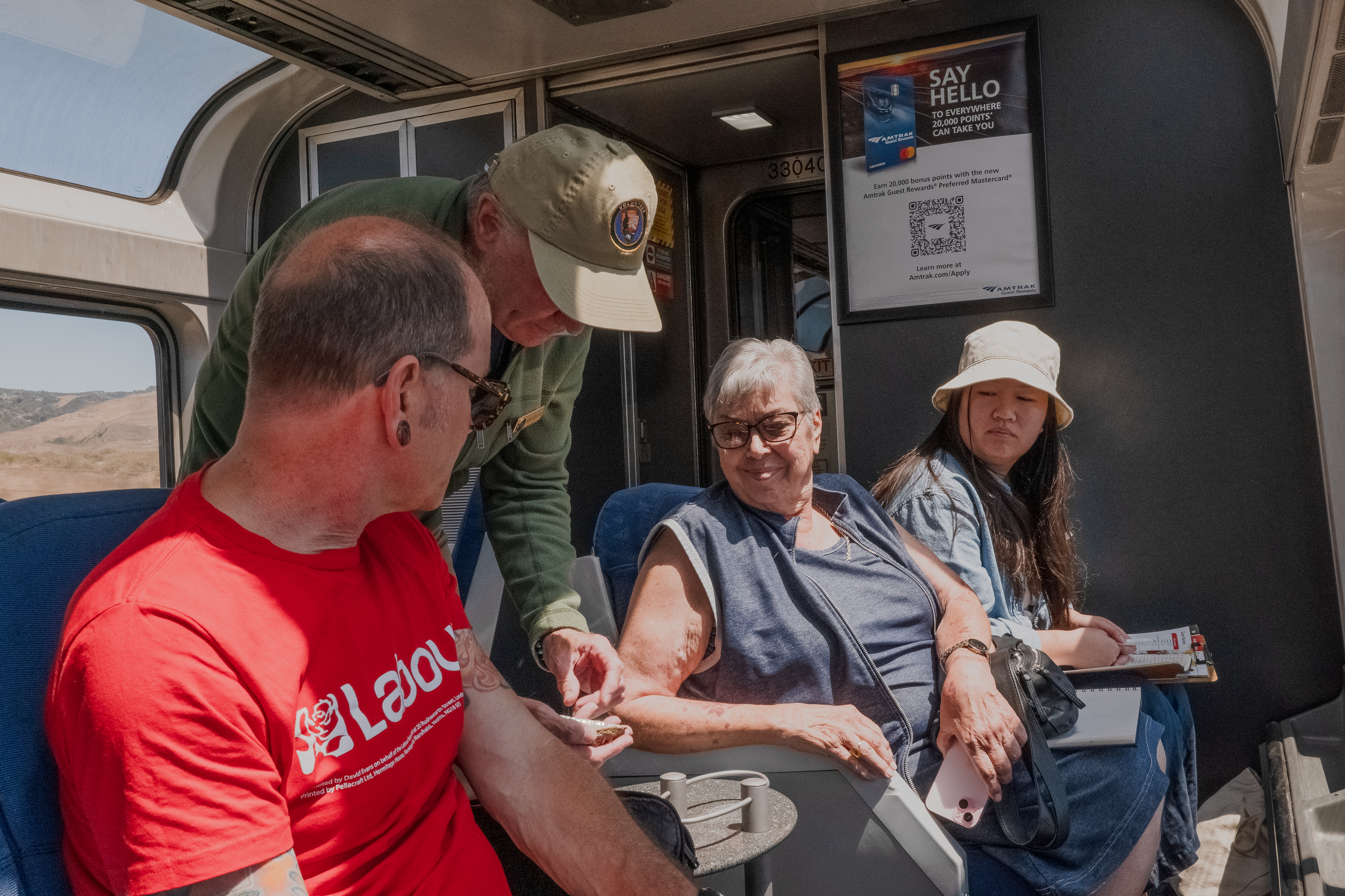 A Trails&Rails VIP showing an object to passengers on Amtrak Coast Starlight
