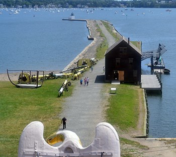View looking down on Derby Wharf, with pedestrians on path and boats in water in distance
