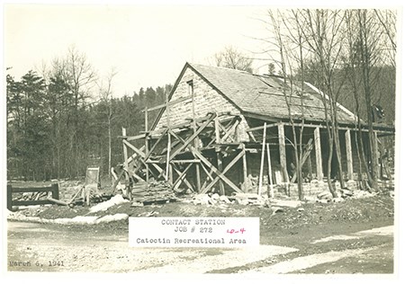Wooden scaffolding encases a brick building, under construction in spring of 1941.