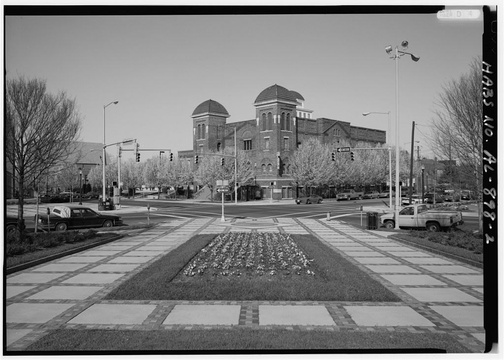 16th Street Baptist Church, across the street from Kelly Ingram Park, where flowers grown in a planting in wide walkway.