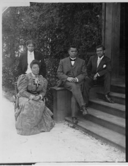 Booker T. Washington, Margaret Murray Washington, and their two sons on the front steps of the house