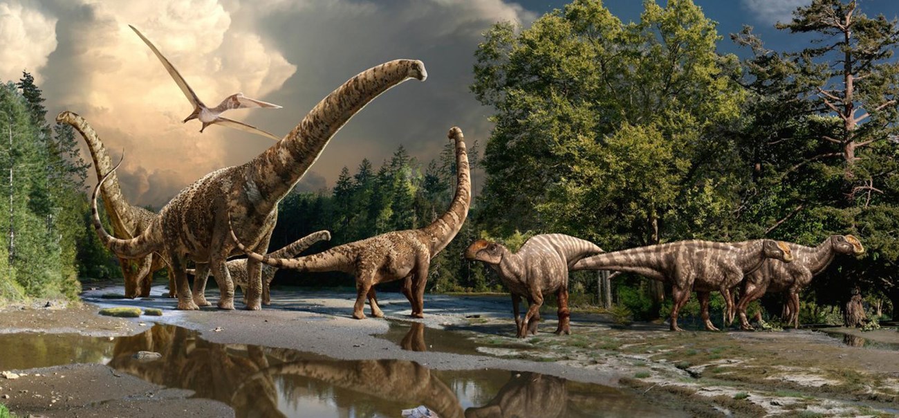 Mural showing several prehistoric animals walking on the bank of a  stream