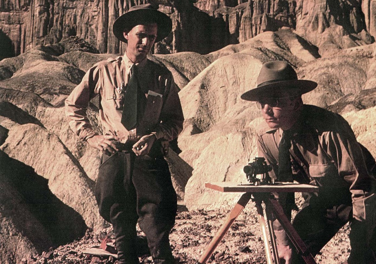 two rangers with survey equipment