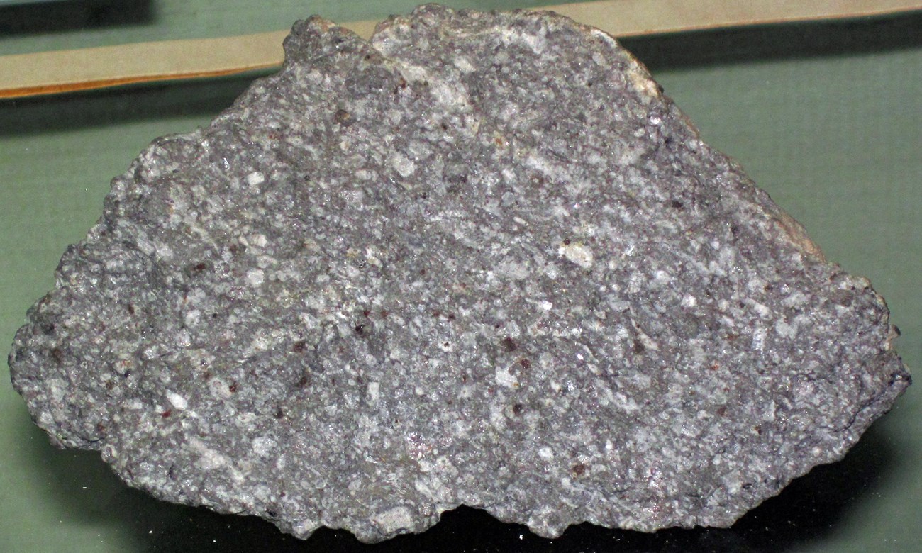 Photo of a grey rock with small crystals