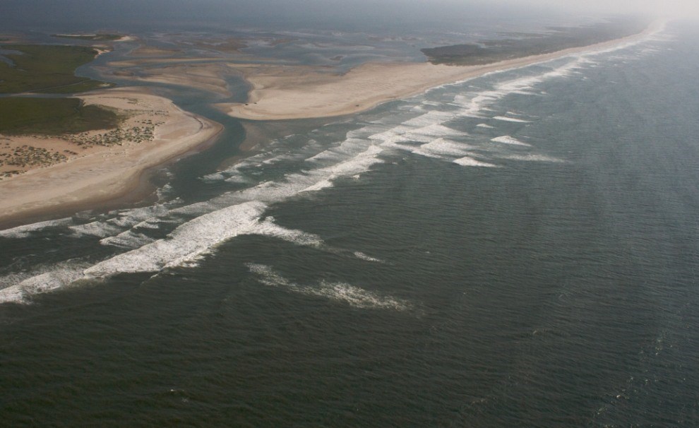 aerial view of coastline with inlet