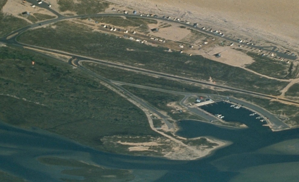 aerial view of developed coastline with roads and marina
