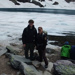 two people standing in front of icy bay