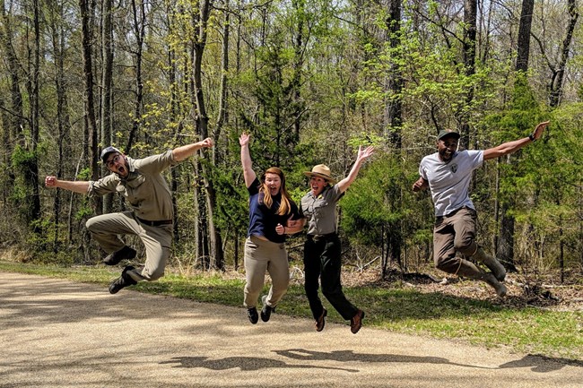 Group of young people jumping for joy in nature.