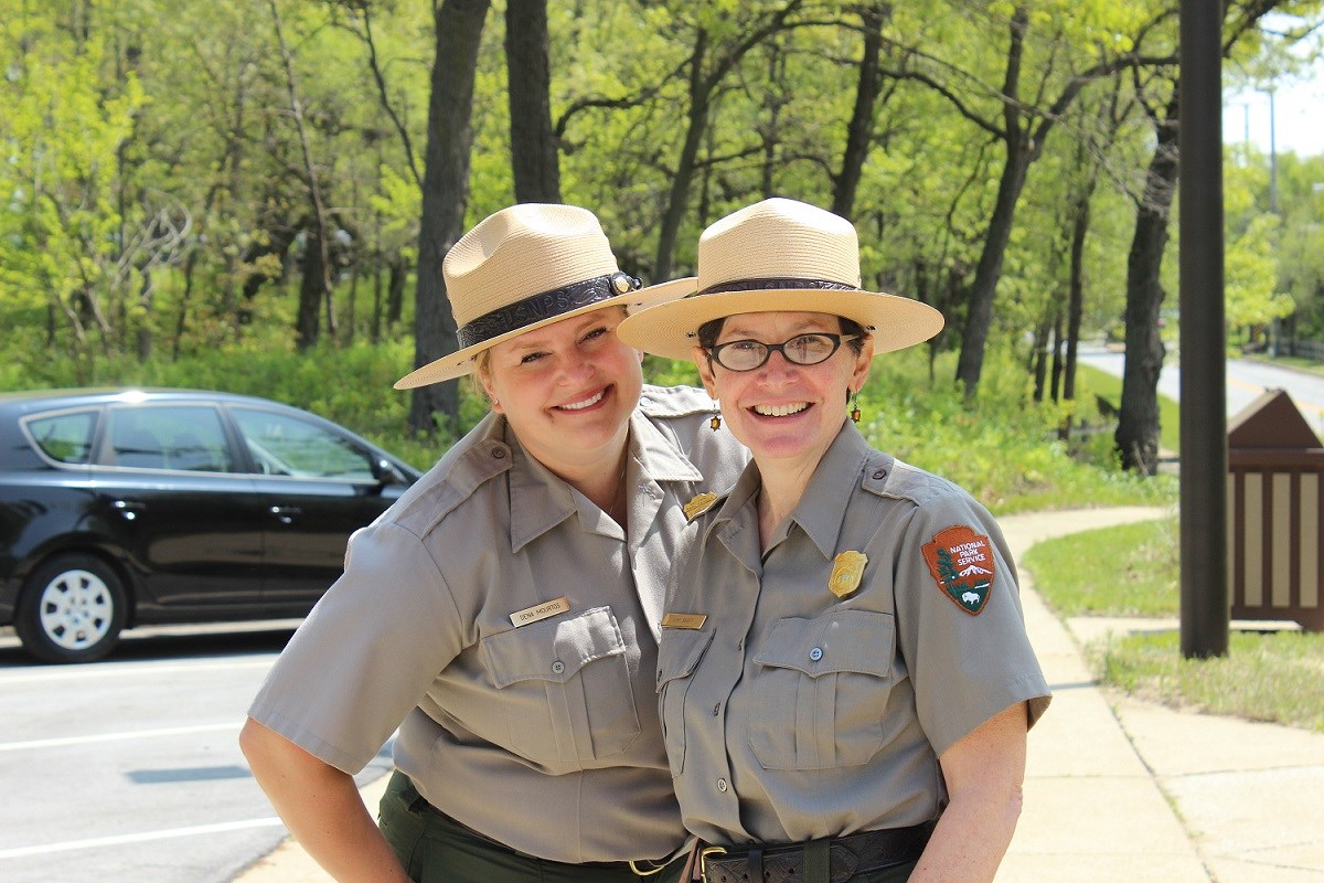 Two female park rangers smiling