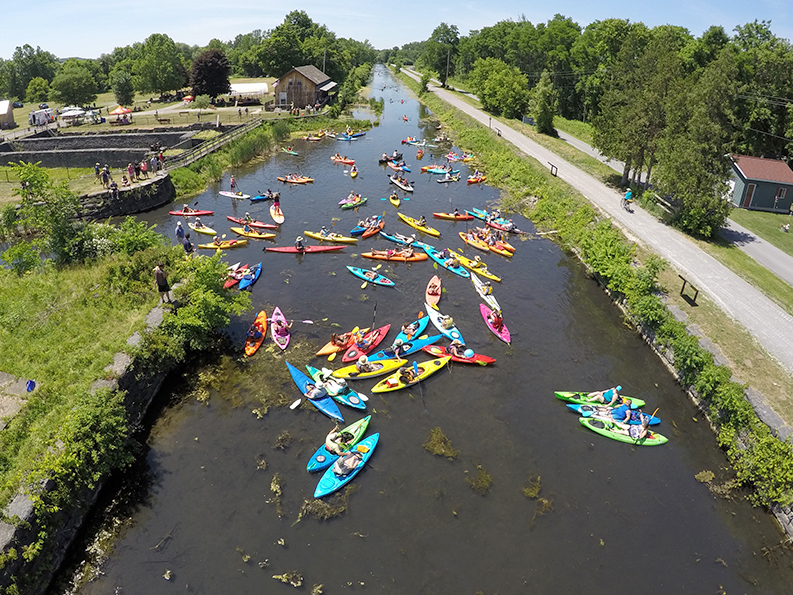 Aerial shot of kayaks on the Erie Canal during the Boat Float event near Chittenango