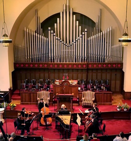 Erie Philharmonic orchestra players performing in First Presbyterian Church sanctuary