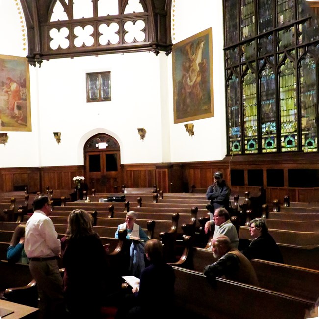 Attendees of the Partners for Sacred Places Town Hall Meeting sit in the pews of a church.