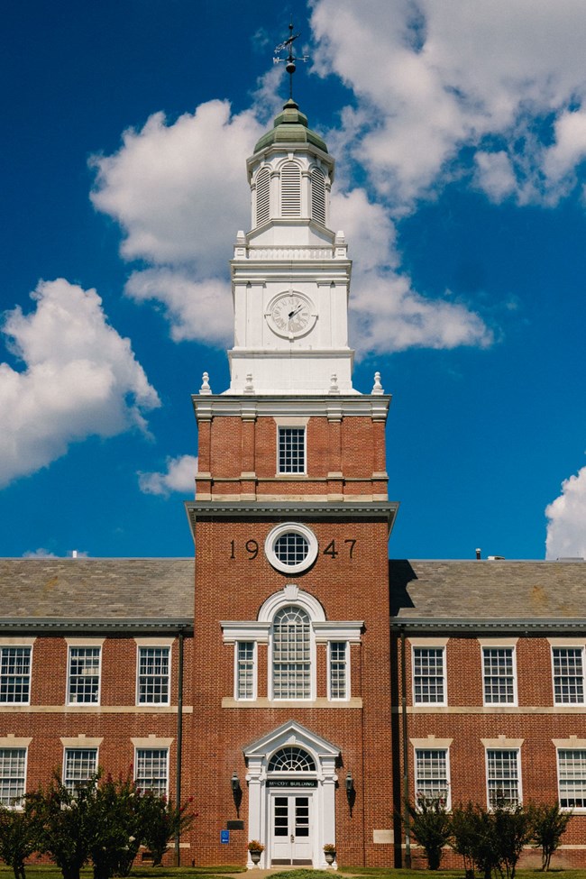 Historic red brick building with a white clock tower