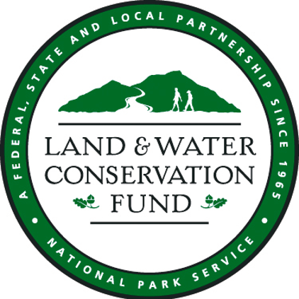 LWCF text below mountains in center of a ring with text of  A federal, state and local partnership since 1965, national park service