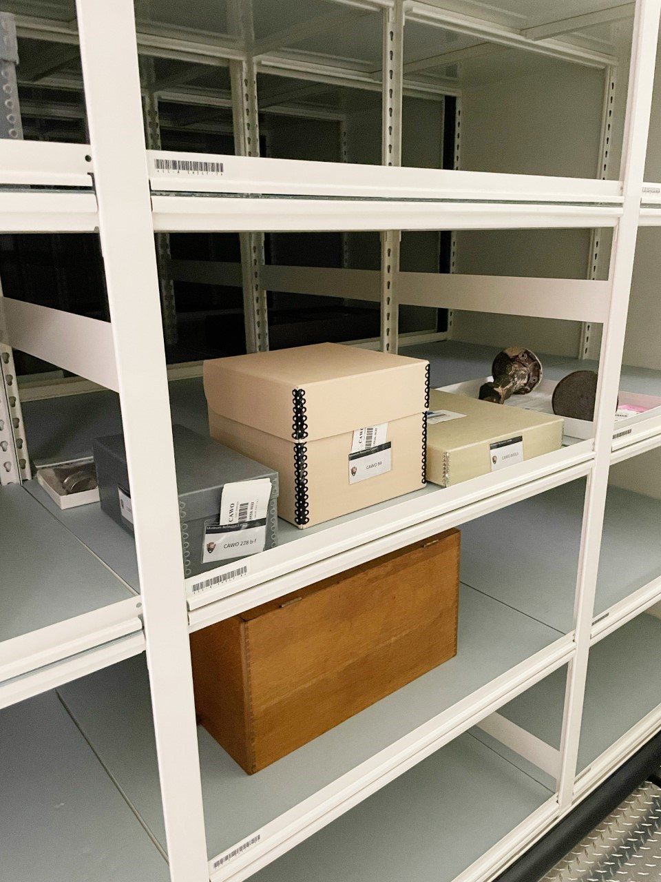 White metal shelves holding several boxes.