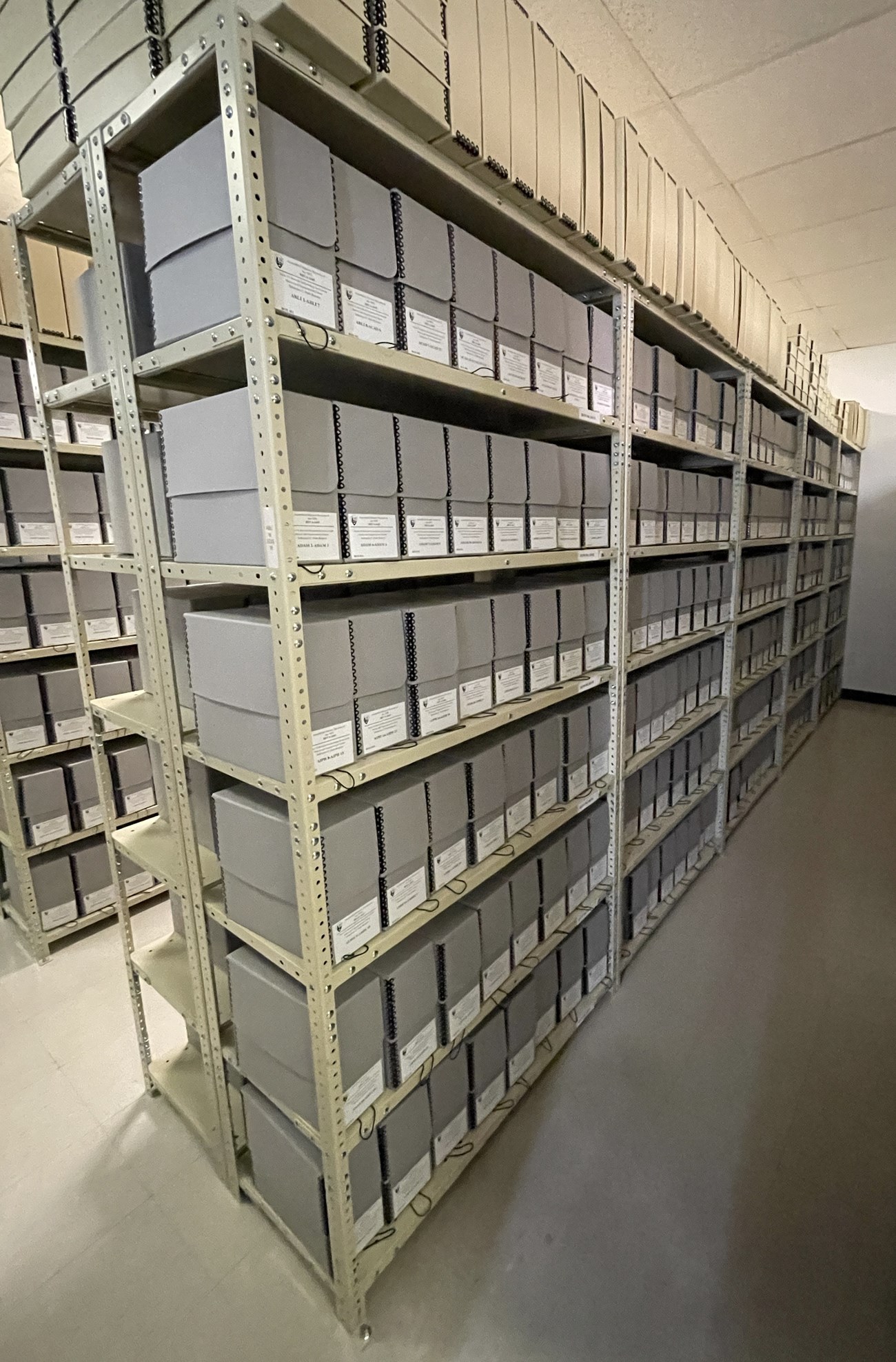 Metal shelves holding archives boxes.