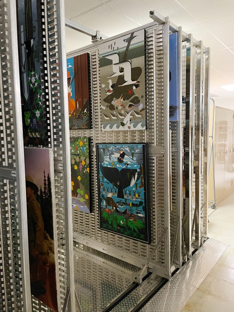Art rack holding several colorful paintings.