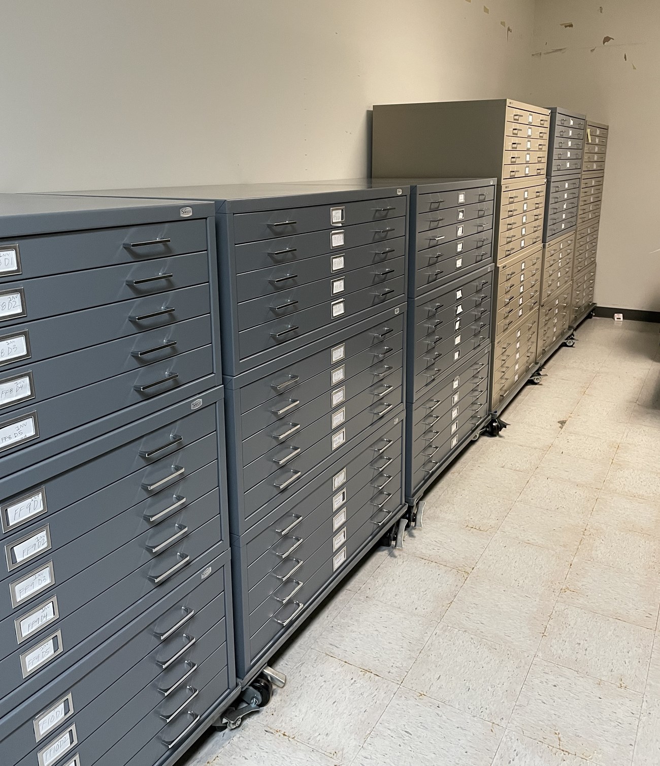 A grouping of gray and beige flat file stacks.