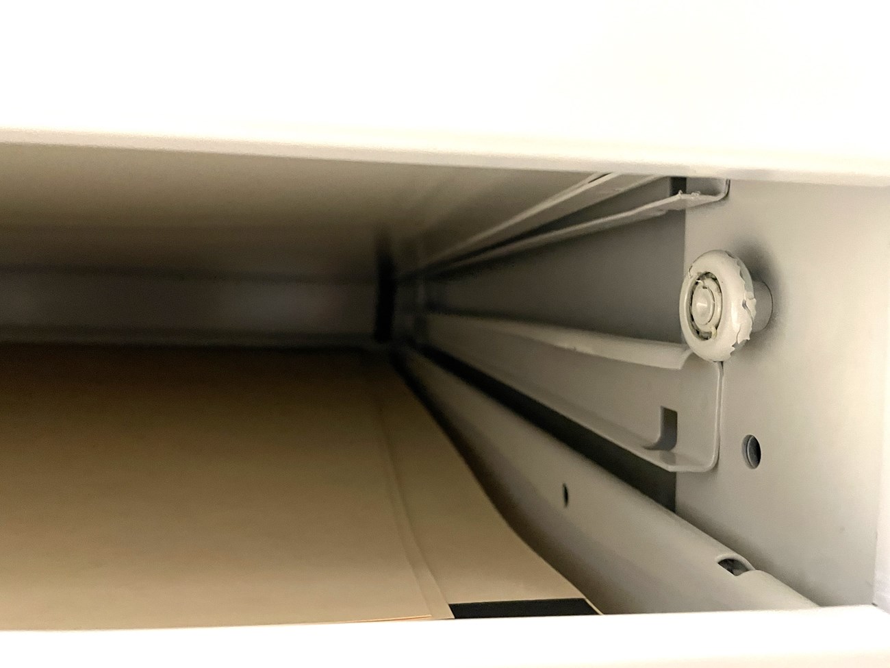 Interior of a flat file drawer showing the track mechanism.