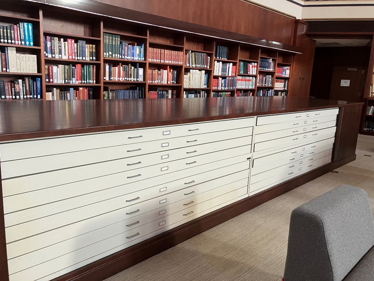 Very large white flat file set into a wooden cabinet.