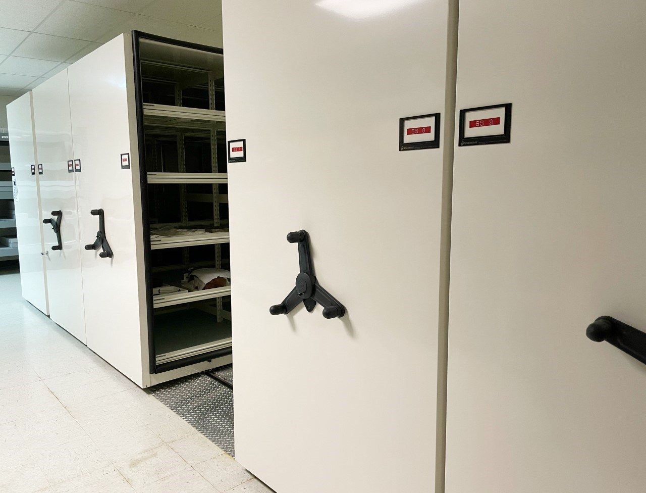 A white compact storage unit with shelves.