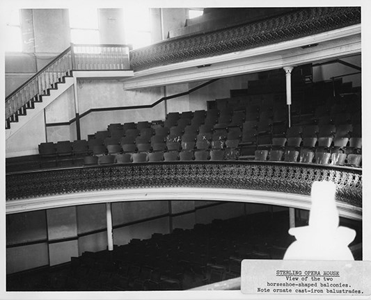 Image of theater balcony detailed with elaborate wood molding.