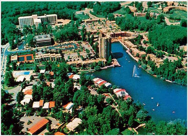 Image of buildings, roads, parking lot, and lake.