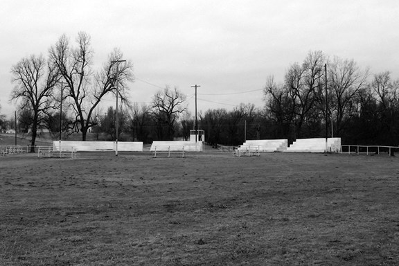 Image of performance area with lawn and bleachers.