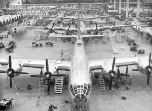 Black and white image of B-29 airplanes in different stages of production.