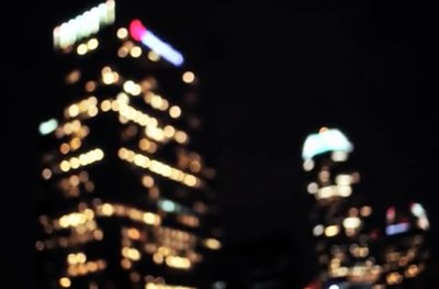 Slightly out of focus lit skyscraper buildings at night