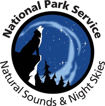 Natural Sounds and Night Skies logo features a howling wolf under a starry night sky