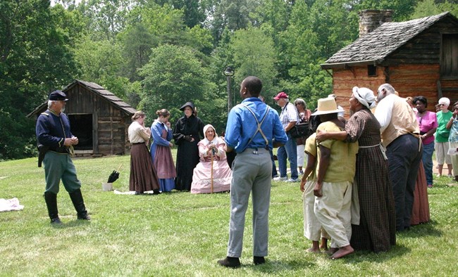 Reenactment of a US Army soldier talking to a group of enslaved Americans announcing the end of slavery
