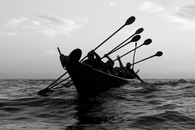 chumash paddling traditional tomol on the ocean