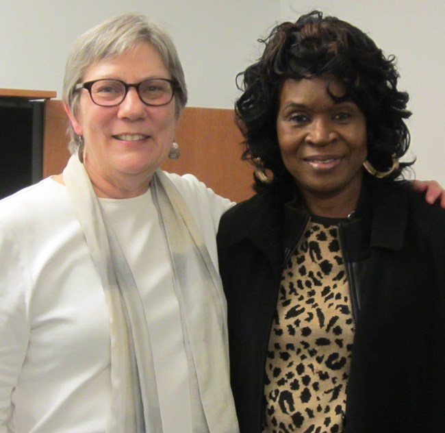 Two women stand side-by-side, smiling for the photograph