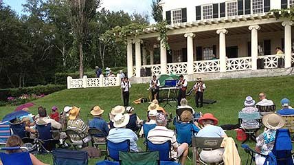 An audience enjoys a summer outdoor concert on the lawn at Saint-Gaudens National Historic Site.