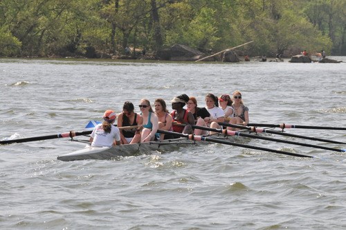 Several women in a canoe row in the Potomac River