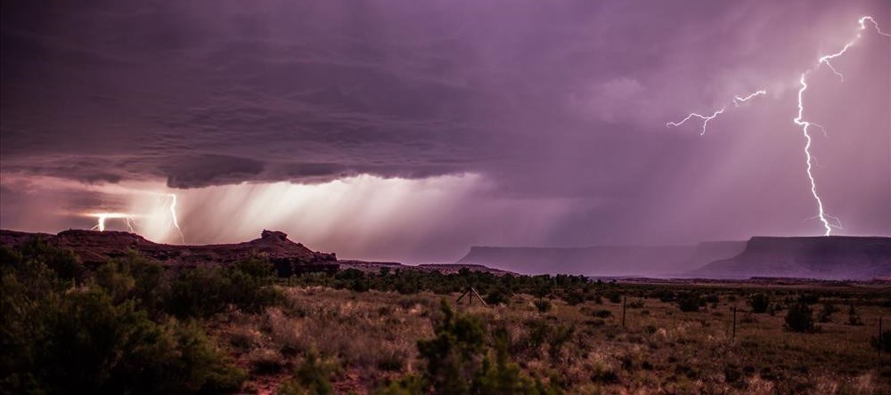 Lightening storm moves over desert.
