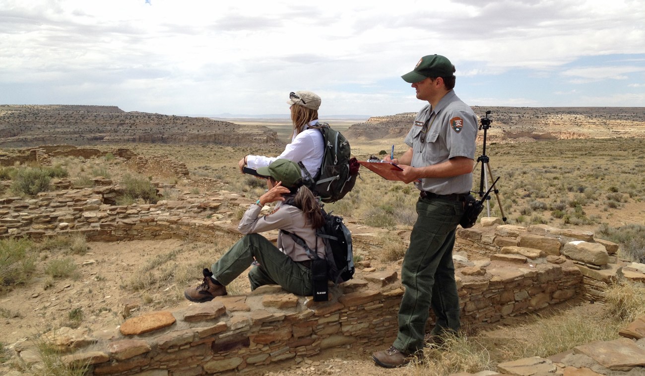 Three visual resource inventory team members rating scenic quality while looking at a view at Chaco Culture National Historical Park in New Mexico.