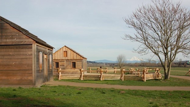 Historic wood-framed buildings and fence.