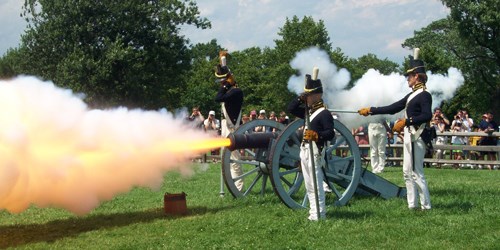 Soldiers firing a cannon