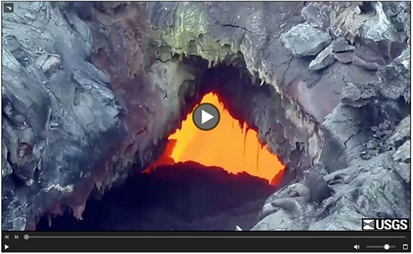 Screen capture of online video play frame with image of molten lava seen through a hole in the ground.